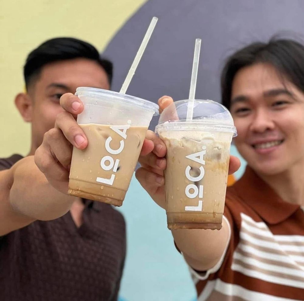 Friends toasting with Loca iced coffee